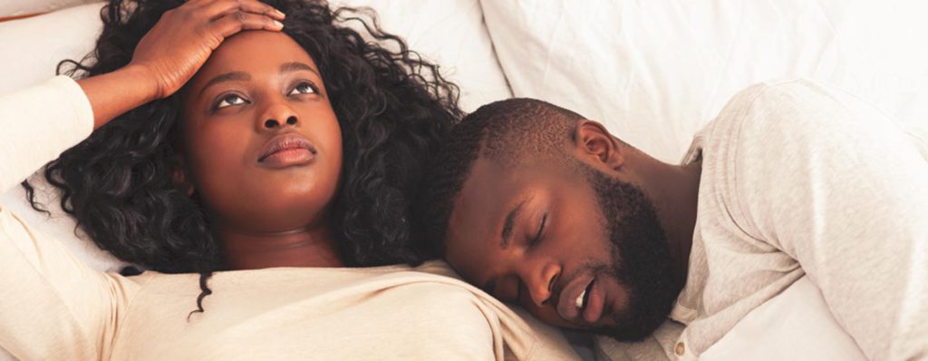 couple sleeping one snoring